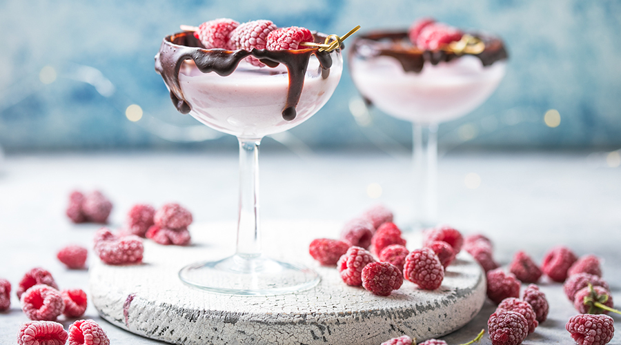 two chocolate strawberry martini cocktails in martini glasses