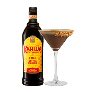 A bottle of Kahlúa Coffee Liqueur next to a brown cocktail in a martini glass